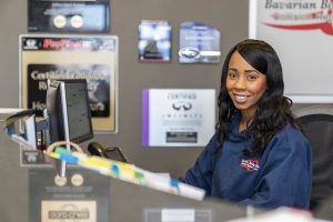 Receptionist sitting at counter at Body Repair Center